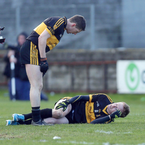 Kieran O'Leary checks on the injured Colm Cooper